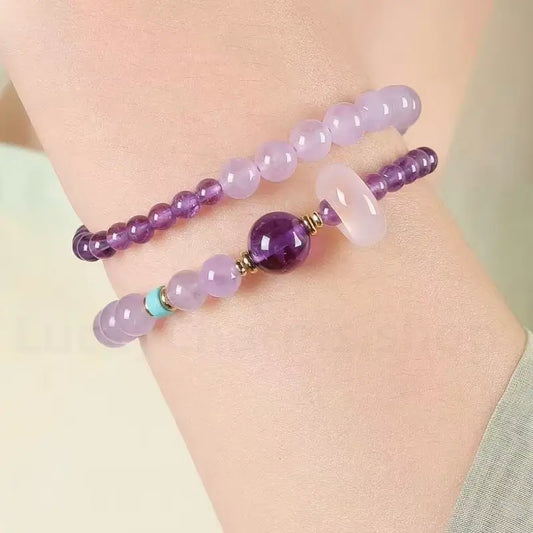 A woman's wrist wearing the natural purple amethyst double-strand healing crystal bracelet for a minimalist elegant look