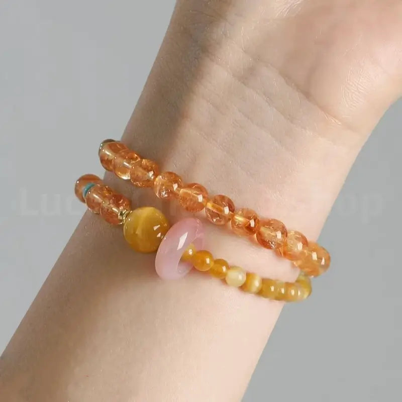 Close-up on-wrist view of the natural faceted citrine gemstone bracelet for wealth and good fortune attraction