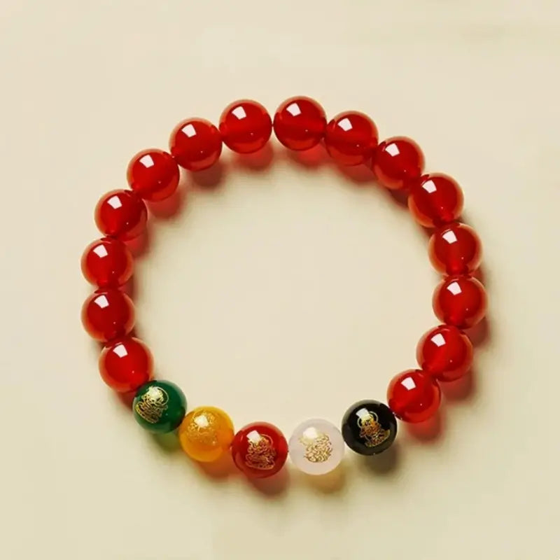 Top-down view of a 10mm natural red agate protection bracelet with multi-color wealth god beads representing five elements