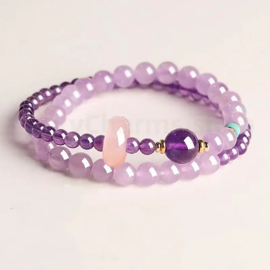 Natural amethyst purple double-strand beaded bracelet with a pink jade donut charm and dark purple main bead on a white background