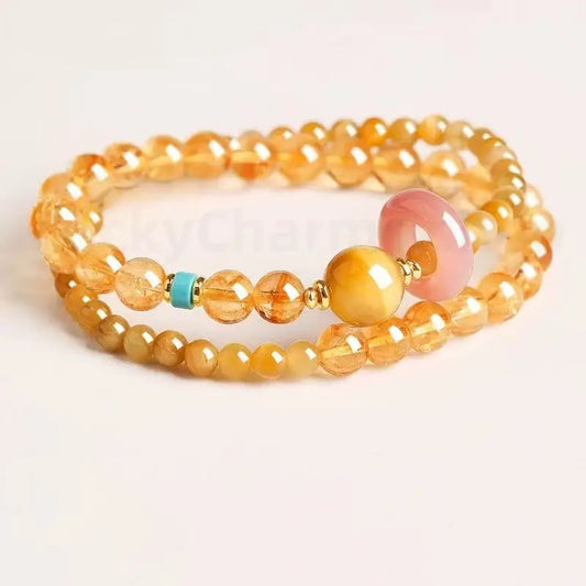 Natural citrine and yellow chalcedony double-strand wealth bracelet with a pink chalcedony donut and turquoise accent