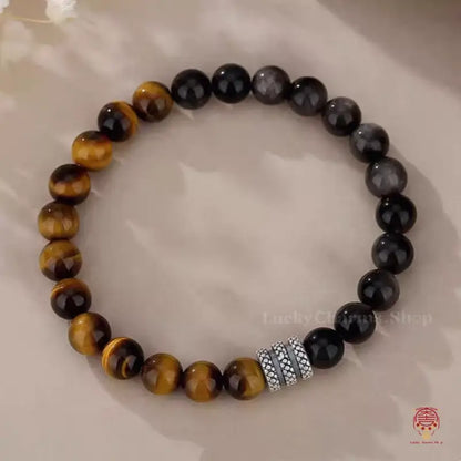 Triple protection crystal bead bracelet featuring shiny yellow tiger's eye, gray eagle eye, and black obsidian.