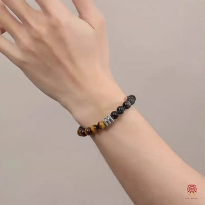 A model showcasing the natural mixed tiger's eye crystal energy bracelet on their wrist for daily styling.