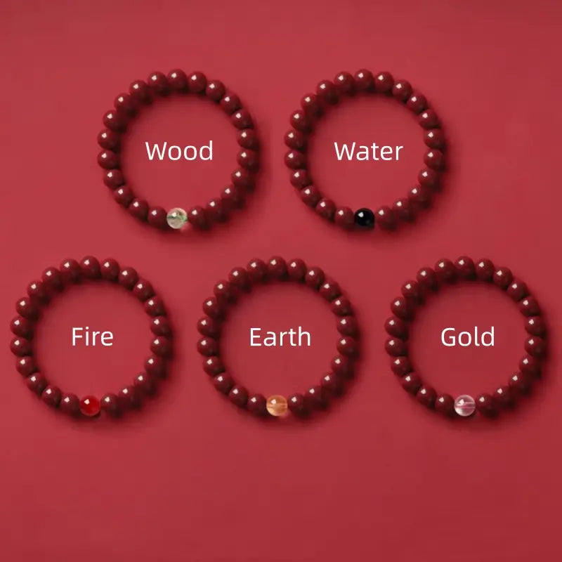Five natural cinnabar Five Elements energy bracelets with distinct gemstone accent beads on red background.