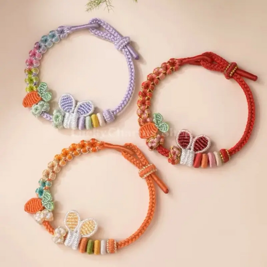 Hand-woven DIY bunny ear and carrot bracelets shown in purple, red, and orange cord colors.